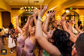 At Garré Vineyard in Livermore, California, single ladies reach for the flying bridal bouquet at this wedding celebration.